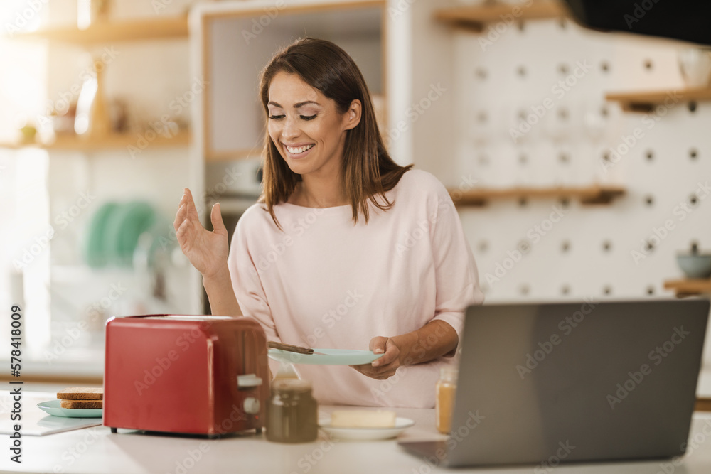 Wall mural Woman Using Toaster In The Kitchen