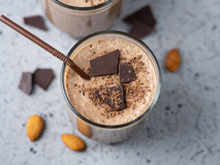 Milk smoothie cocktail with cocoa, chocolate, almonds and cinnamon. Two glasses of dessert