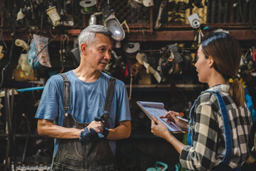 Asian woman customer talking with professional mechanic worker or workshop owner, client checking a maintenance job with garage automobile technician, business of car repair transportation service
