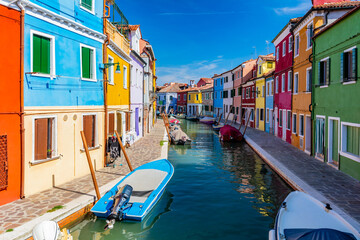 Fototapeta na wymiar Burano, Italy with colorful painted houses along canal with boats