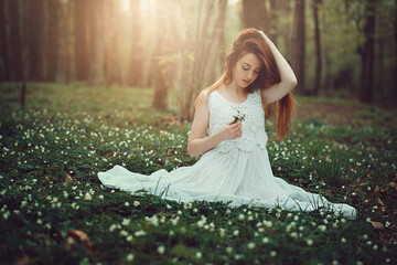 Romantic young woman in beautiful meadow