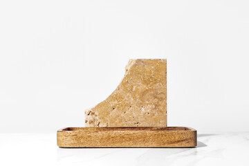 Beauty cosmetics product presentation mockup podium made with wooden tray and travertine stone on white background. Stylish minimal scene for body care products exhibit, front view, copy space.