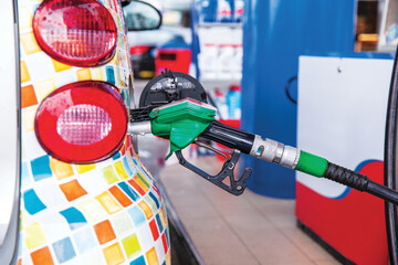 Fill up a car with gasoline fuel at petrol station