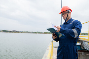 Water plant maintenance technicians, mechanical engineers check the control system at the water...