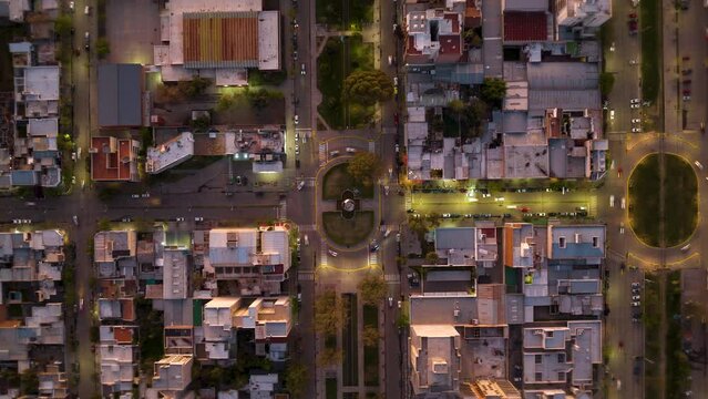 Ascending zenithal shot of the city. The city lights are turning on in stages. Orthogonal urban layout, also called reticular or grid (hypodamic). General Roca, Argentina.