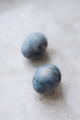 Sprigs Painted Easter eggs and on a linen tablecloth, marble eggs. Eco.Trend. Copy space