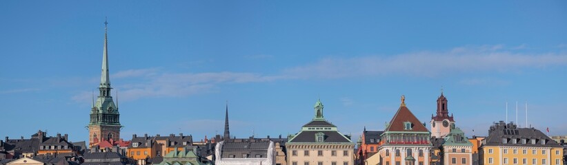 Fototapeta na wymiar Panorama. Roofs and facades in the old town Gamla Stan, a sunny spring day in Stockholm