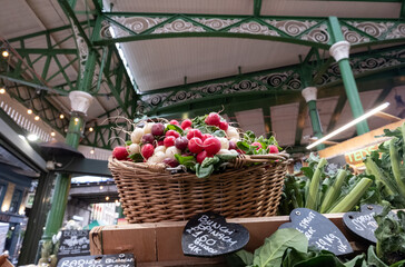 Market stall at Borough Market, partially covered urban market in Southwark, east London. Basket of...