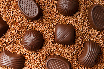 Candies in chocolate chips close-up macro photography.
