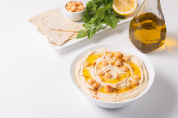 Hummus in a plate with chickpeas, smoked paprika, olive oil and pita. Vegetarian food.