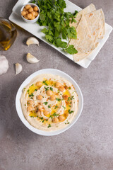 Hummus in a plate with chickpeas, smoked paprika, olive oil and pita. Vegetarian food.
