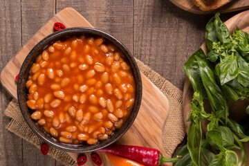 Chili beans on wooden table background. Kidney beans and vegetable Mexican food. 