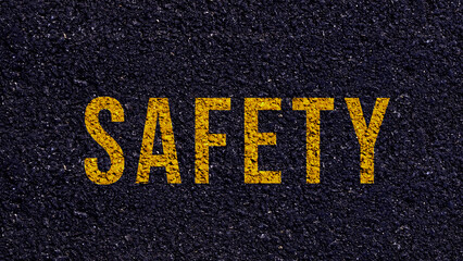 Safety first text written on the road in middle of the asphalt road, Safety first word on street.