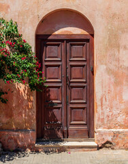 Fototapeta na wymiar Solid wooden door in home in Colonia del Sacramento Uruguay