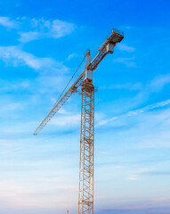 Fototapeta na wymiar Construction tower crane against the blue sky.