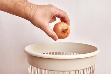 Expired onions are thrown into the trash. Disposal and recycling of food products.