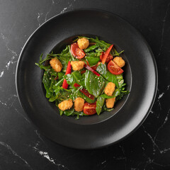 Salad with vegetables, arugula, avocado and fried tofu - close-up