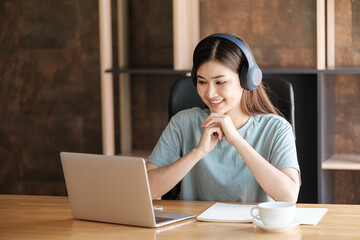 Smart asian Woman with computer online learning at home.