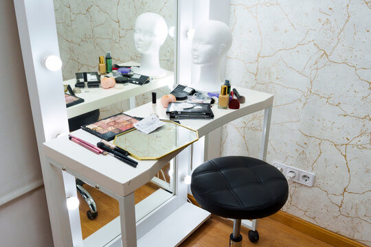 Mirror with a table with make up tools in a backstage
