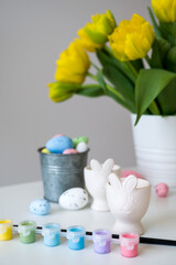 Vertical easter card with pastel egss,flowers,paints etc