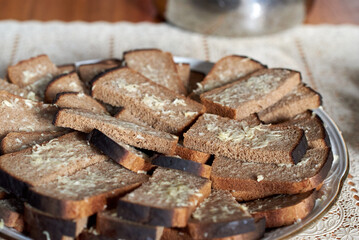 A slice of rye bread, greased with grated garlic