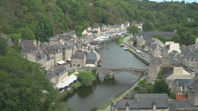 Aerial view of the historic town of Dinan with Rance river with dramatic cloudscape, Cotes-d'Armor department, Bretagne, northwestern France.