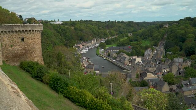 Aerial view of the historic town of Dinan with Rance river with dramatic cloudscape, Cotes-d'Armor department, Bretagne, northwestern France.