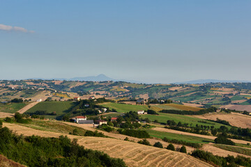 Fototapeta na wymiar Aerial view of lush dramatic landscape and hills against clear blue sky during summer season
