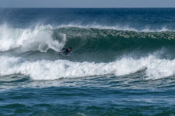 Bodyboarder surfing ocean wave