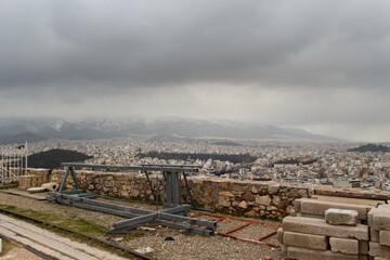 Obraz premium View on Athens streets from Pantheon on winter during cloudy cold day with snow on the mountain in background