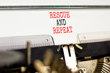 Rescue and repeat symbol. Concept words Rescue and repeat on white paper typed on old retro typewriter on beautiful white background. Business rescue and repeat concept. Copy space.