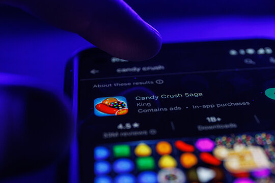 Candy crush saga app game on smartphone screen. Close up shot of candy crush game