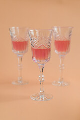 three vintage crystal glasses with grapefruit cocktail