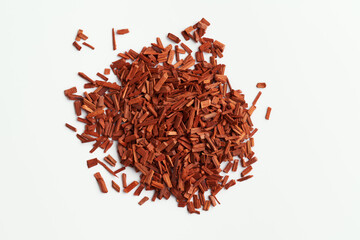 Red sandalwood chips on white background