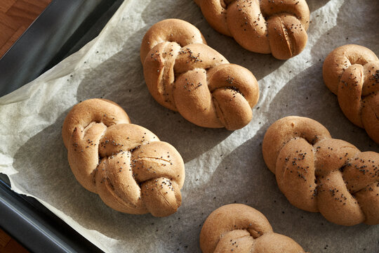 Homemade braided bread rolls or buns made from whole grain spelt flour