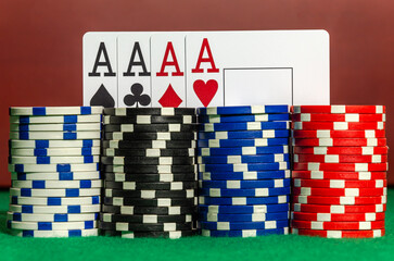 Four ace cards on the background of poker chips in a casino - obrazy, fototapety, plakaty