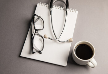 Stethoscope, notebook and coffee cup