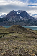 Impressive mountains and a lake with turquoise water at Torres del Paine National Park in Chile,...