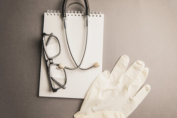 Stethoscope, notebook and gloves