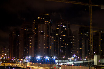 Fototapeta na wymiar Lights of the night city. Large residential areas and office buildings.