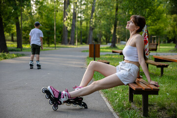 Girls and on roller skates relaxes after a practice.