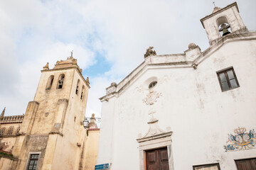 Fototapeta na wymiar Church of Our Lady of the Assumption (left) and Church of Mercy (right) in Alvito town, district of Beja, Alentejo, Portugal - December 2022