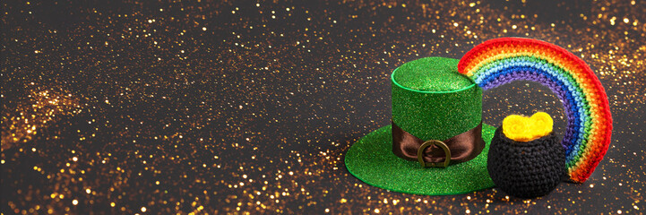 St Patrick's Day concept. Banner of a green hat, knitted black cauldron with coins and a...