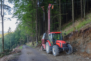 Traktor and forest cableway for timber concentration uphill, downhill on beskid mountains.