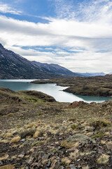 Impressive mountains and a lake with turquoise water at Torres del Paine National Park in Chile,...