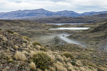 Driving through the huge and stunning National Park Torres del Paine in Chile, South America