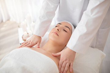 Fototapeta na wymiar Closeup of beautiful woman enjoying body massage at modern wellness center