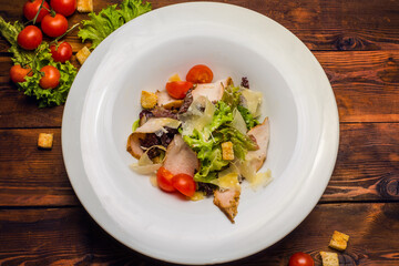 Salad with salmon and vegetables in a white plate