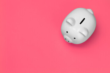 White piggy bank viewed from the top on pink background
