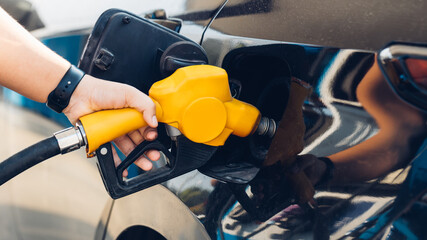 Man Refill and filling Oil Gas Fuel at station. Gas station - refueling. To fill the machine with...